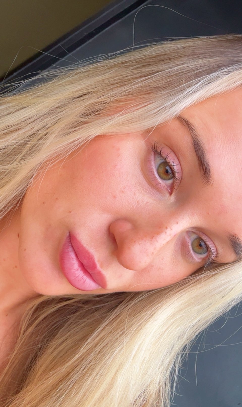 Light coverage faux freckles with varied placement across the cheeks and nose